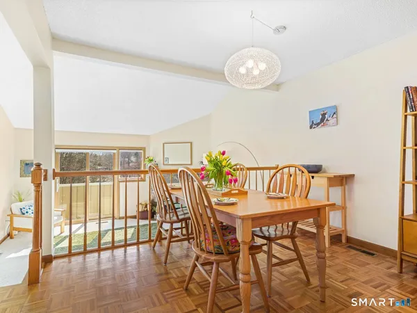 a view of a dining room with furniture and wooden floor