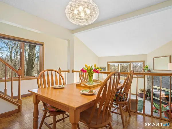 a dining room with furniture a rug and a large window