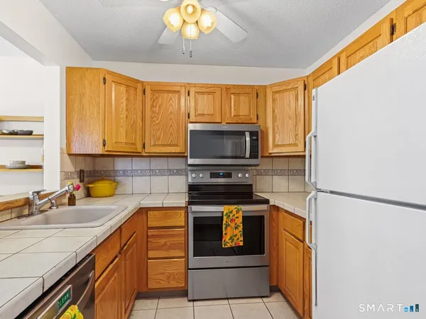 a kitchen with a sink a stove and cabinets