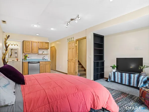 a bedroom with a bed and wooden floor