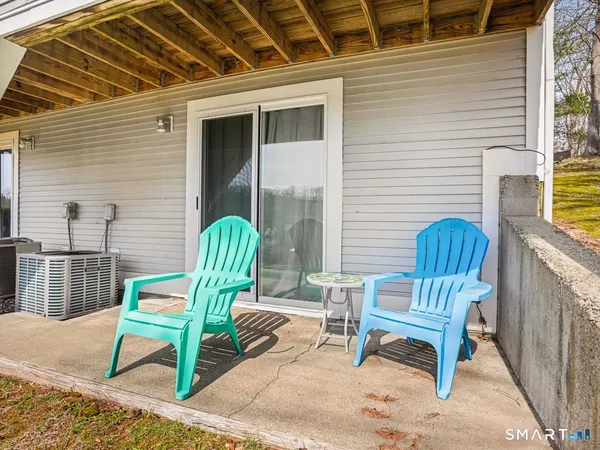 a view of a house with backyard and sitting area