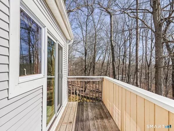a view of balcony with wooden floor and fence