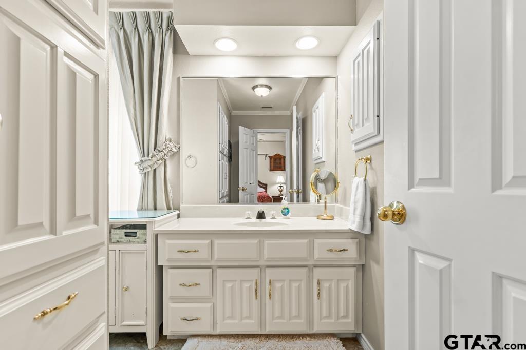 106 Cheyenne Street Gilmer, TX 75644 - Photo 13 of 48 a bathroom with a sink vanity and mirror