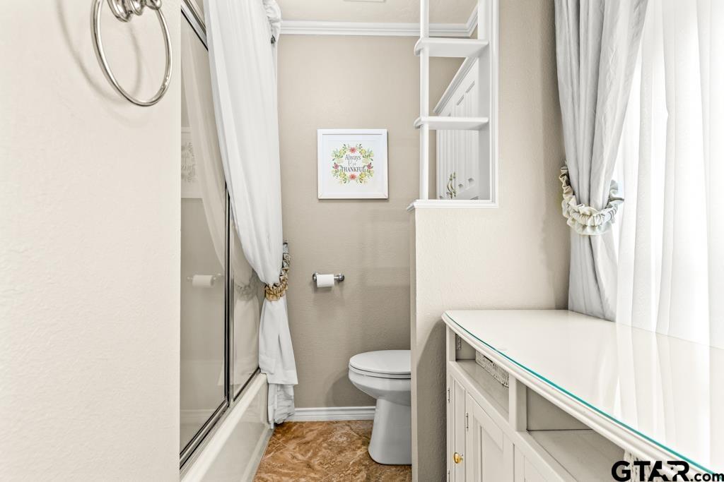 106 Cheyenne Street Gilmer, TX 75644 - Photo 15 of 48 a bathroom with a granite countertop sink toilet and shower