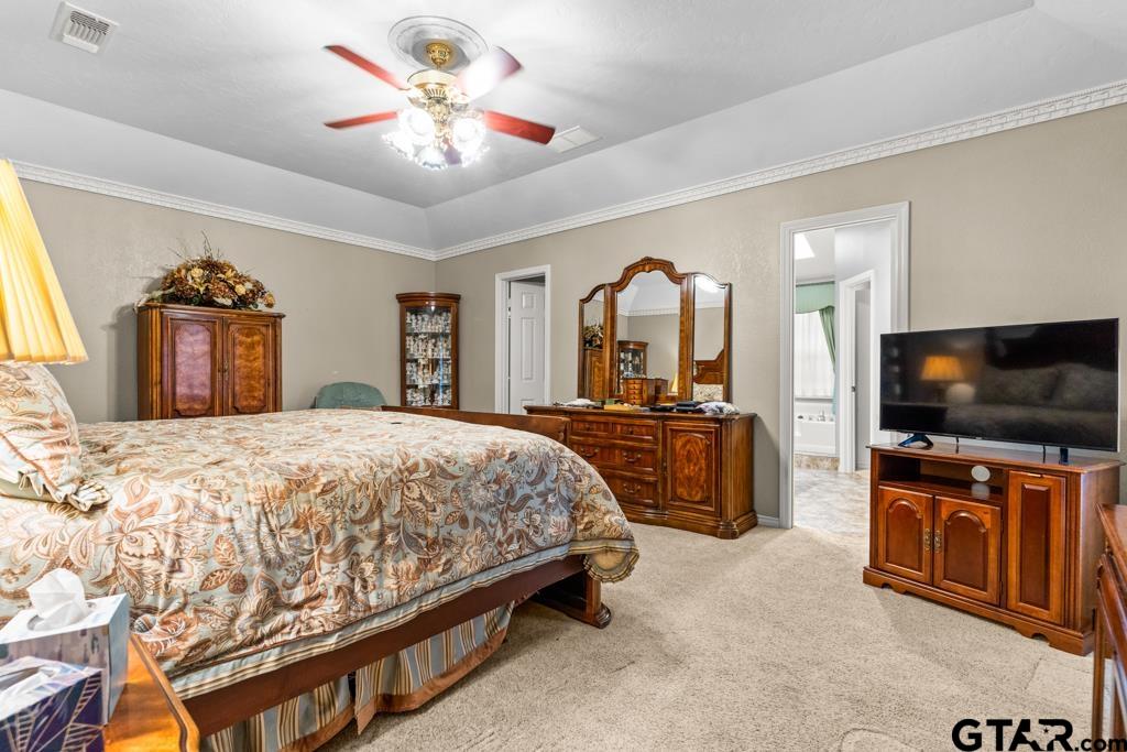 106 Cheyenne Street Gilmer, TX 75644 - Photo 19 of 48 a bedroom with a bed and a flat screen tv