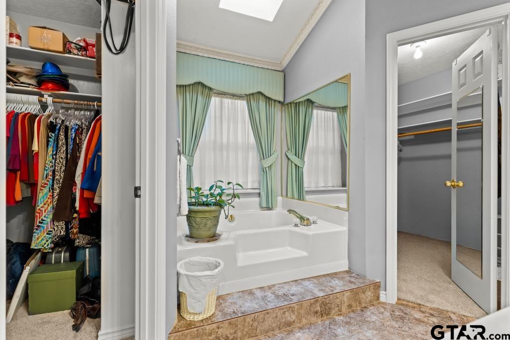 106 Cheyenne Street Gilmer, TX 75644 - Photo 20 of 48 a view of walk in closet with clothes and shoes