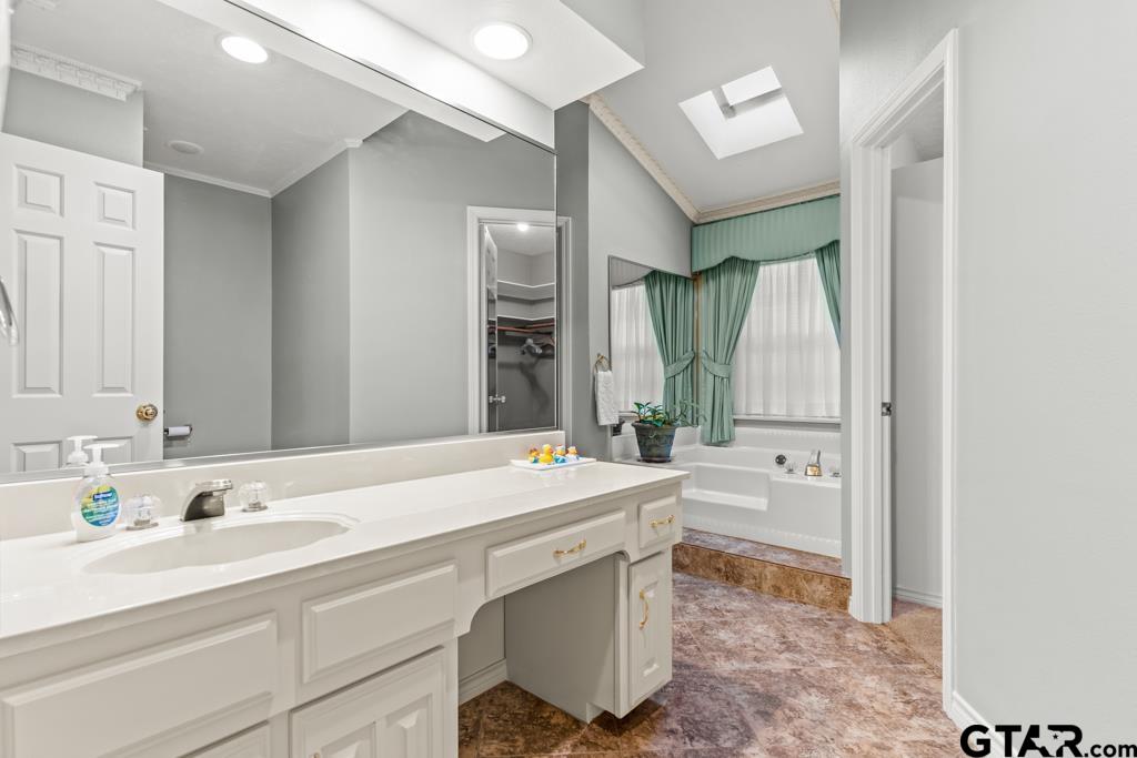 106 Cheyenne Street Gilmer, TX 75644 - Photo 22 of 48 a bathroom with a sink double vanity mirror and a bathtub
