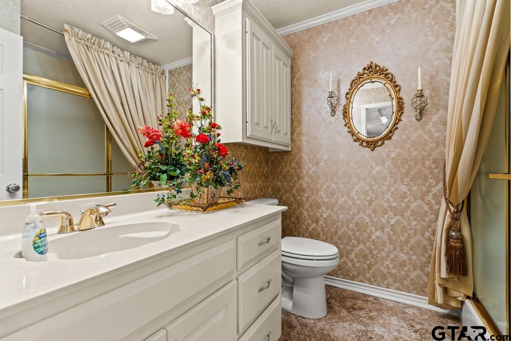 106 Cheyenne Street Gilmer, TX 75644 - Photo 26 of 48 a bathroom with a sink a mirror and a toilet