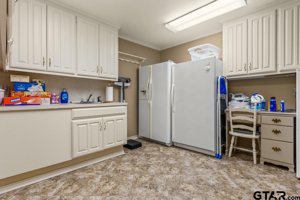 106 Cheyenne Street Gilmer, TX 75644 - Photo 27 of 48 a kitchen with refrigerator and cabinets