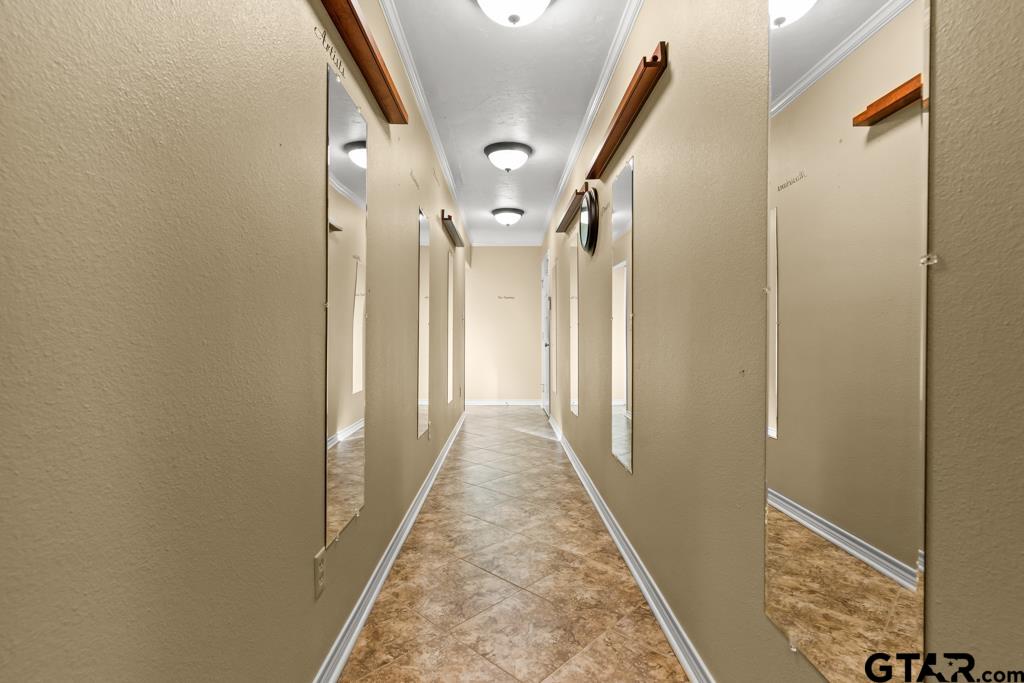 106 Cheyenne Street Gilmer, TX 75644 - Photo 28 of 48 a view of a hallway with wooden floor and glass door