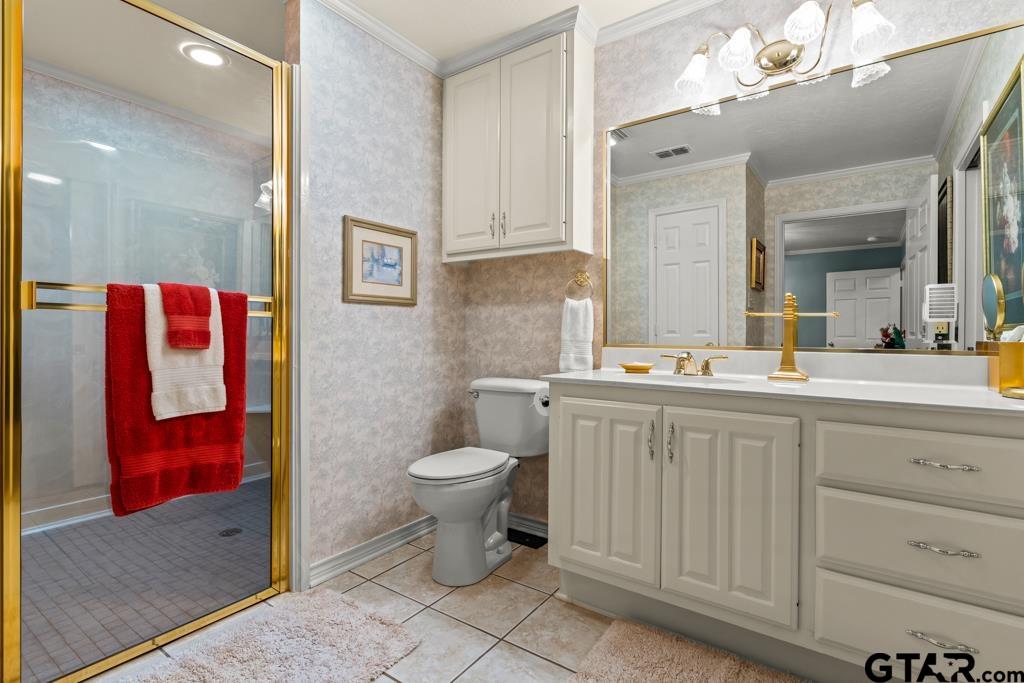 106 Cheyenne Street Gilmer, TX 75644 - Photo 30 of 48 a bathroom with a toilet sink and mirror