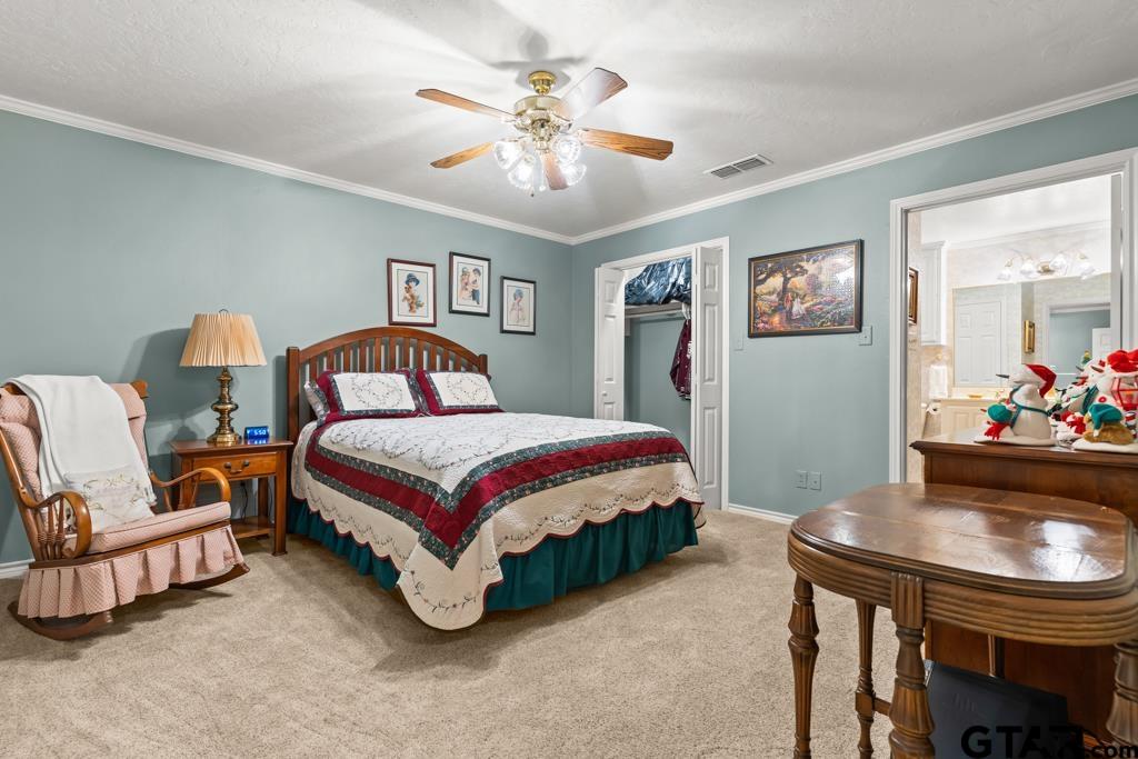 106 Cheyenne Street Gilmer, TX 75644 - Photo 31 of 48 a bedroom with a bed and a chandelier