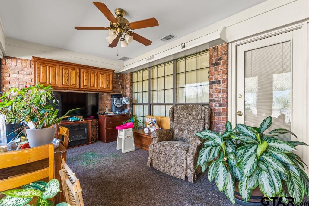 106 Cheyenne Street Gilmer, TX 75644 - Photo 33 of 48 a living room filled with furniture and a potted plant