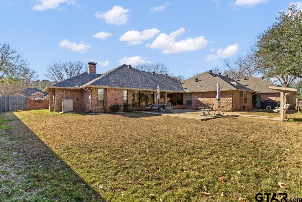 106 Cheyenne Street Gilmer, TX 75644 - Photo 35 of 48 a house with green field in front of it