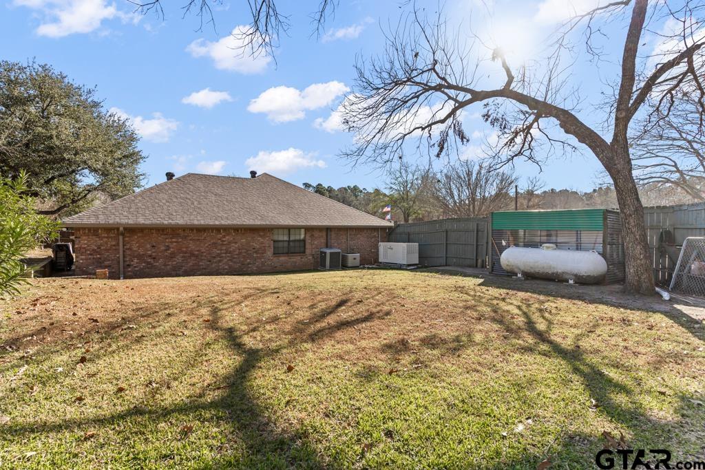 106 Cheyenne Street Gilmer, TX 75644 - Photo 36 of 48 a front view of house with yard and trees around