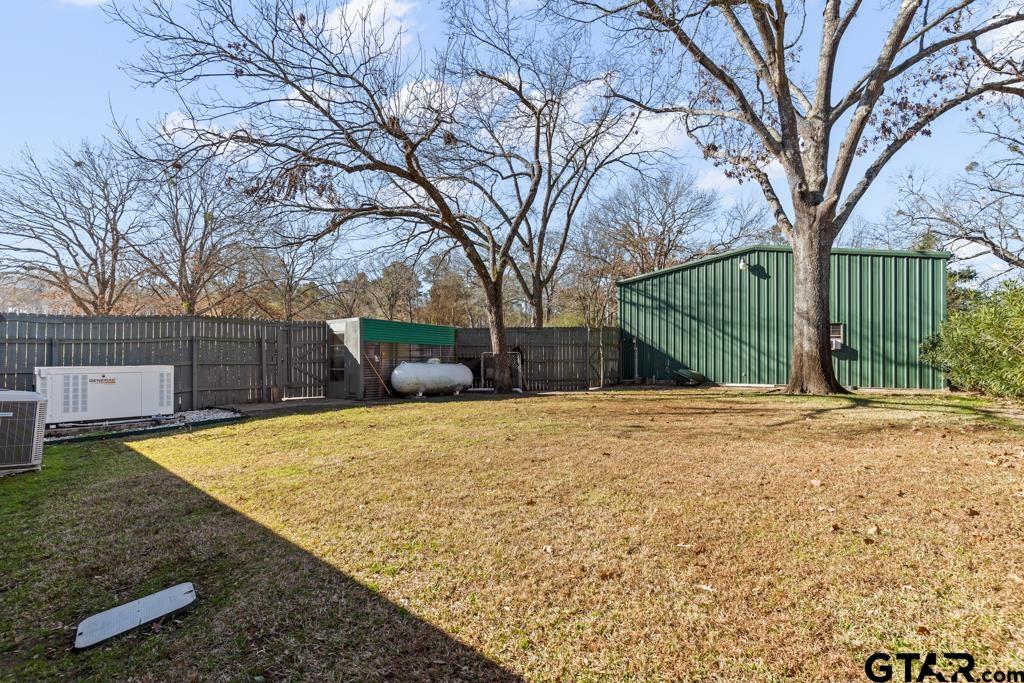 106 Cheyenne Street Gilmer, TX 75644 - Photo 40 of 48 a view of a yard with wooden fence