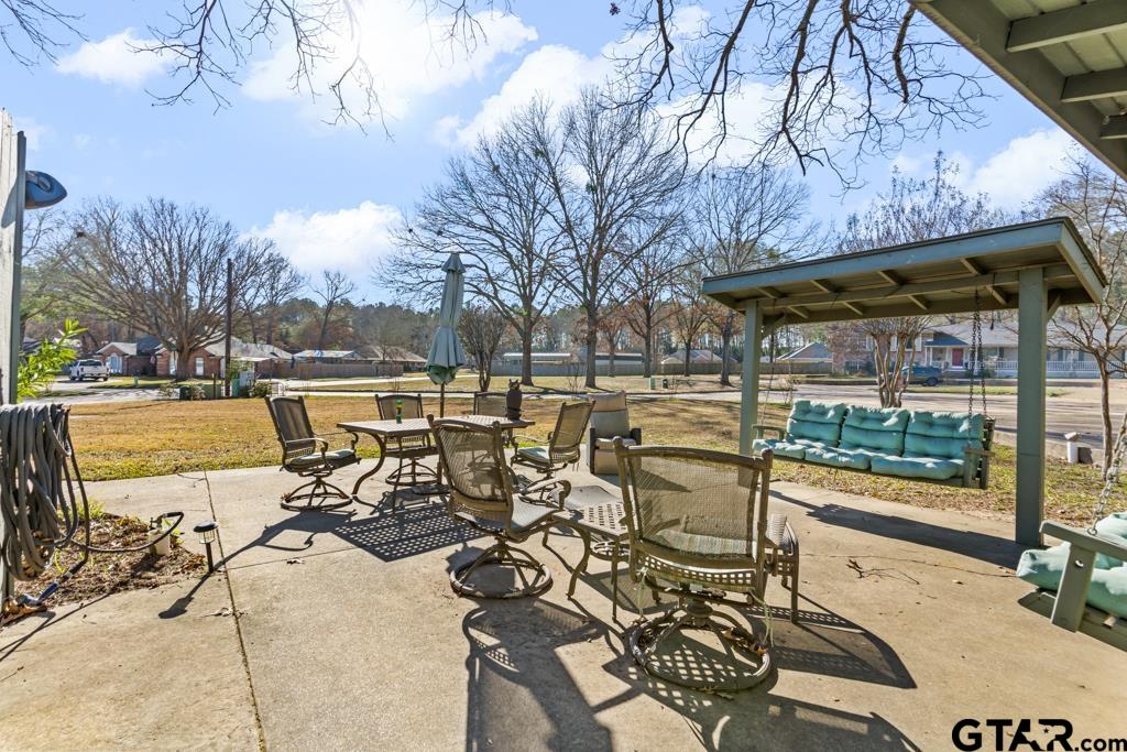 106 Cheyenne Street Gilmer, TX 75644 - Photo 42 of 48 a view of a patio with a table and chairs under an umbrella
