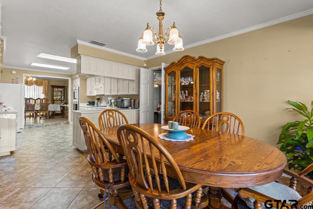 106 Cheyenne Street Gilmer, TX 75644 - Photo 9 of 48 a dining room with furniture a chandelier and window