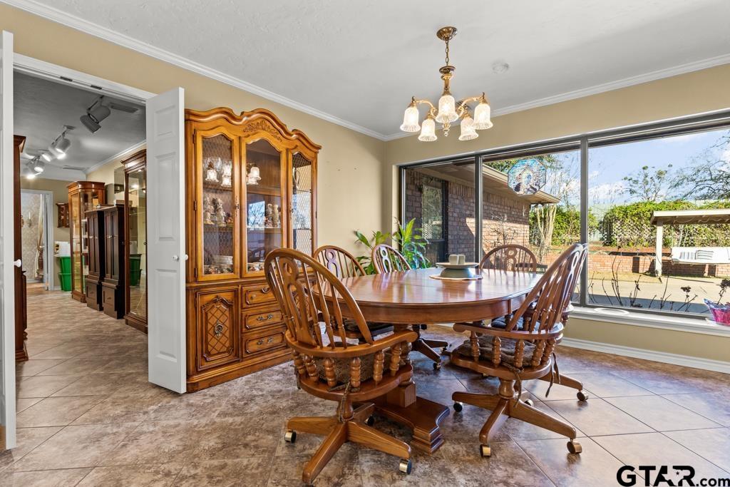 106 Cheyenne Street Gilmer, TX 75644 - Photo 10 of 48 a view of a dining room with furniture wooden floor and chandelier