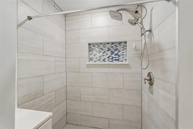 a bathroom with a shower and a shower