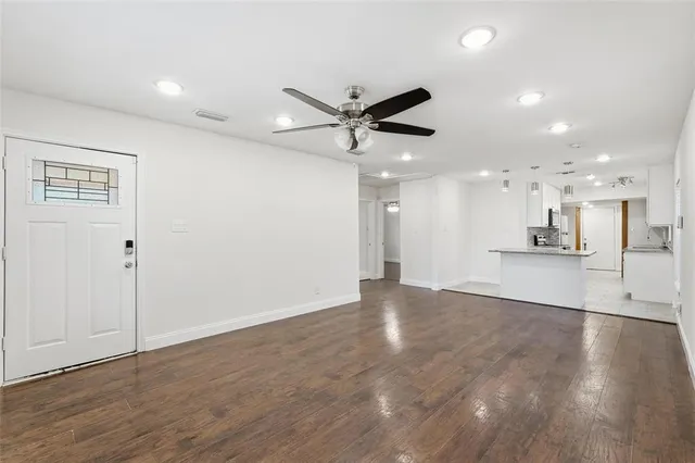 a view of an empty room with a ceiling fan