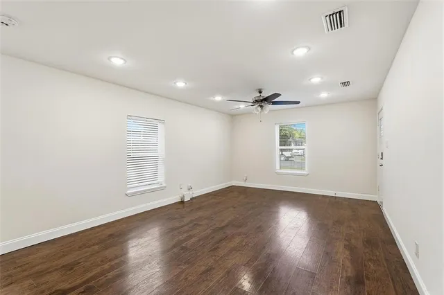 wooden floor in an empty room with a window