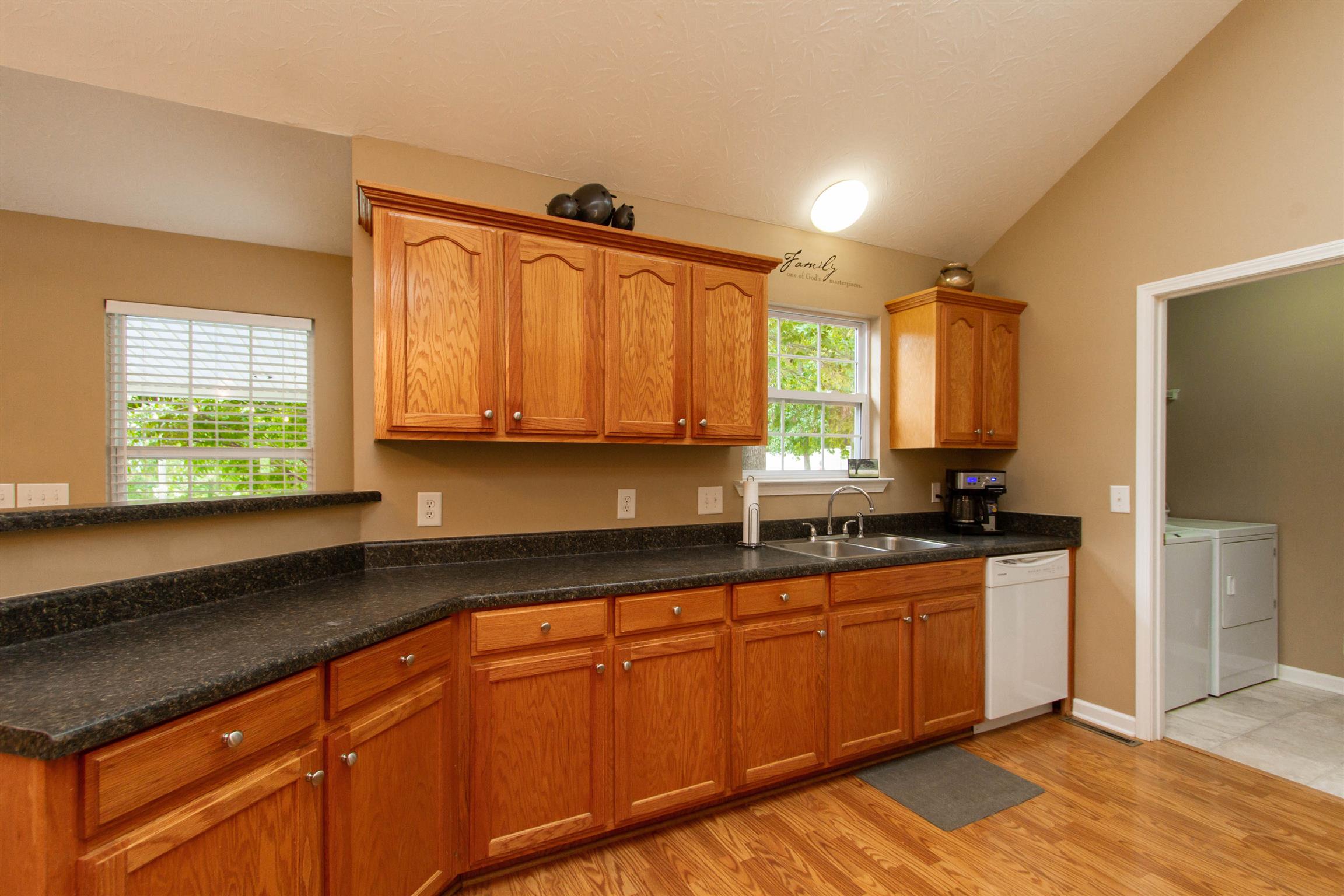 142 Switchboard Road Portland, TN 37148 - Photo 20 of 29 a kitchen with stainless steel appliances granite countertop wooden cabinets a sink and dishwasher with wooden floor