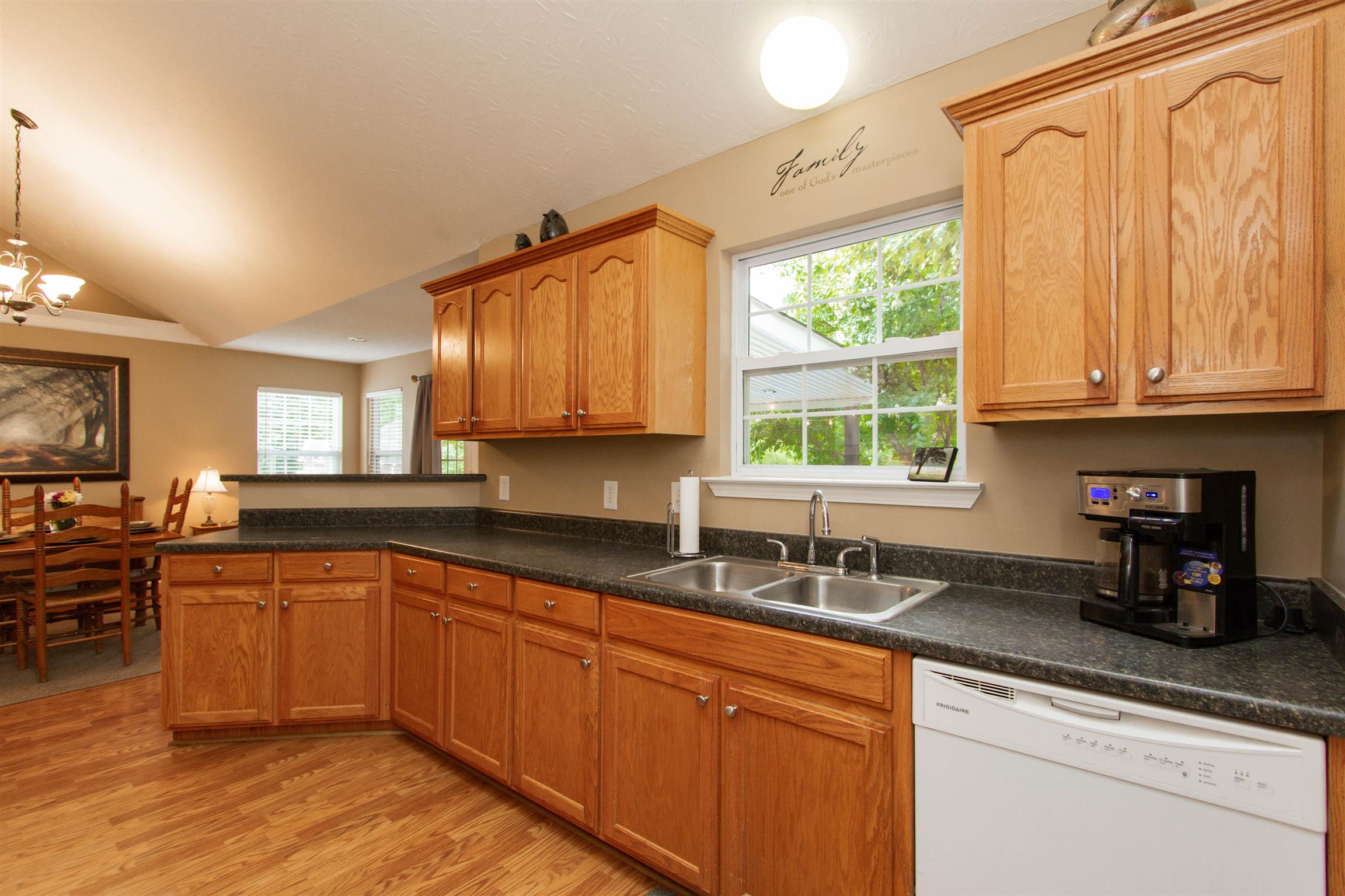 142 Switchboard Road Portland, TN 37148 - Photo 21 of 29 a kitchen with stainless steel appliances granite countertop wooden cabinets a sink and a window