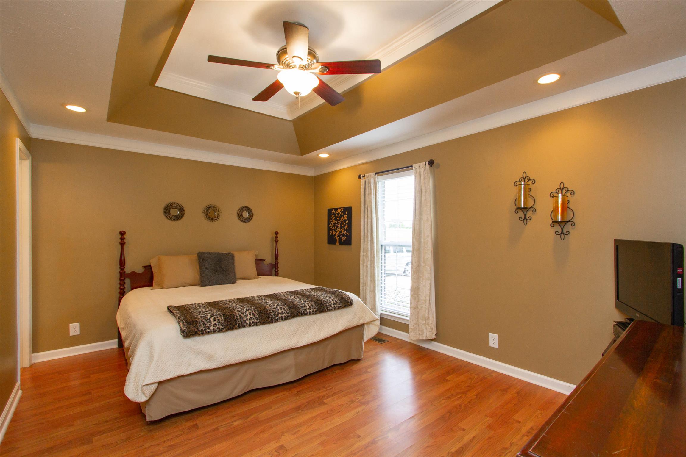 142 Switchboard Road Portland, TN 37148 - Photo 6 of 29 a spacious bedroom with a bed and a flat screen tv