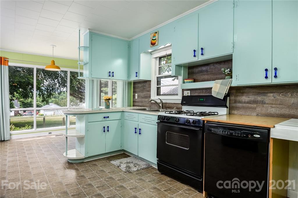 115 Myrtle Street Morganton, NC 28655 - Photo 7 of 29 a kitchen with stainless steel appliances granite countertop a stove a sink and a microwave
