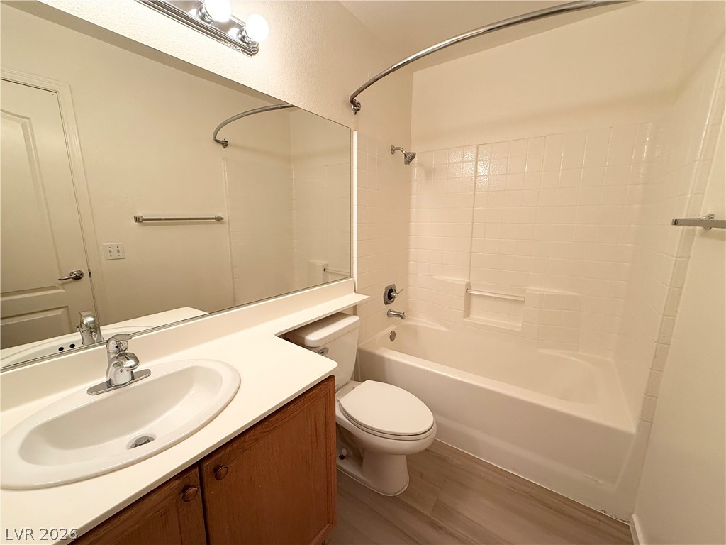 8870 Haviland Road Las Vegas, NV 89123 - Photo 15 of 24 A well-appointed bathroom features a single vanity, a spacious mirror, and a combined shower-tub.