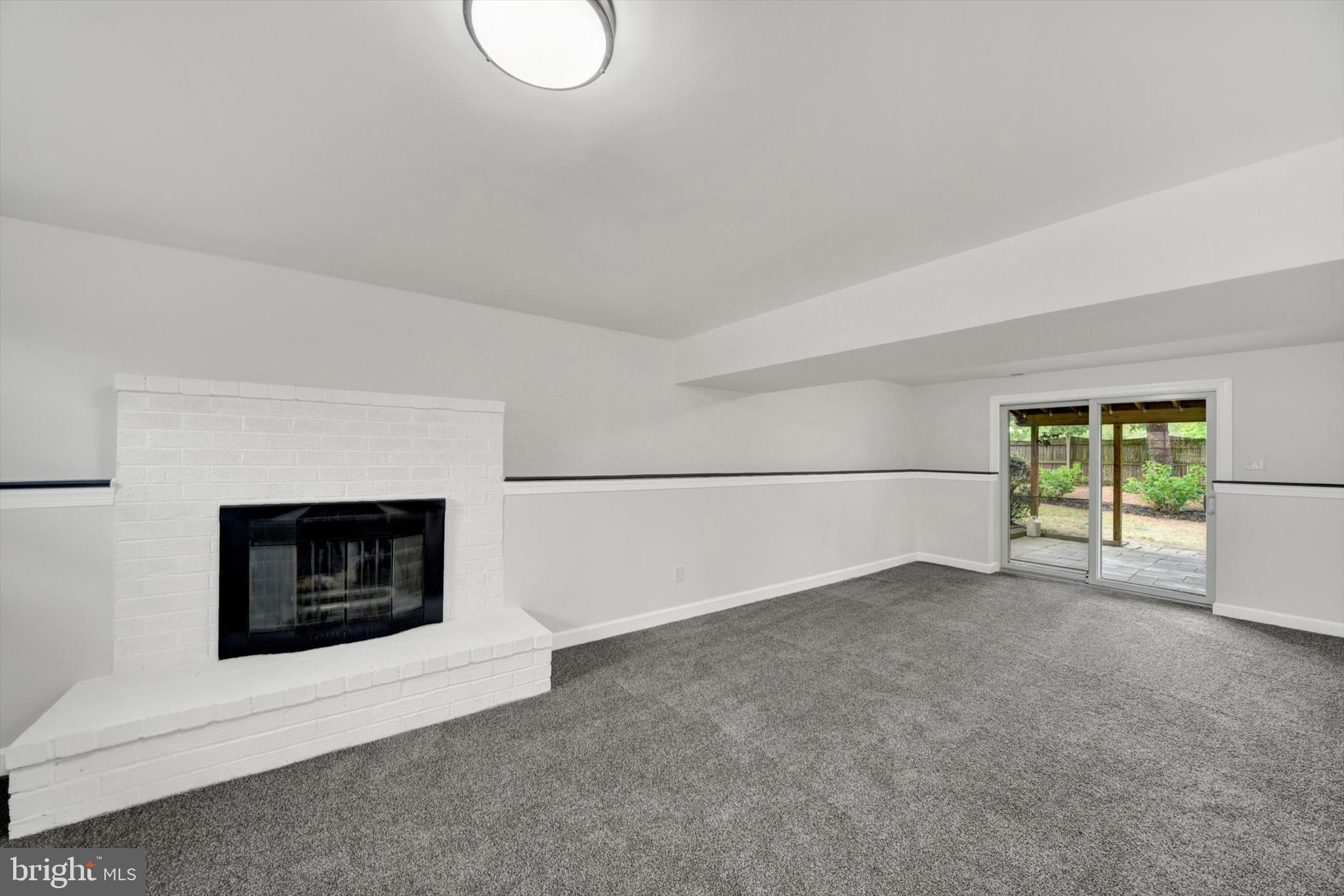 3808 Perryhurst Place Baltimore, MD 21236 - Photo 20 of 29 a view of an empty room with a fireplace and a window