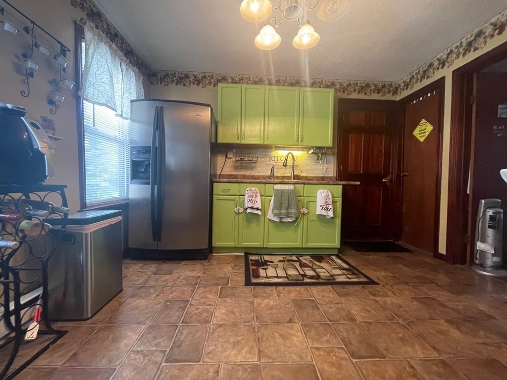 59 Ashley Street Springfield, MA 01105 - Photo 6 of 13 a kitchen with stainless steel appliances granite countertop a refrigerator a stove and a wooden cabinets