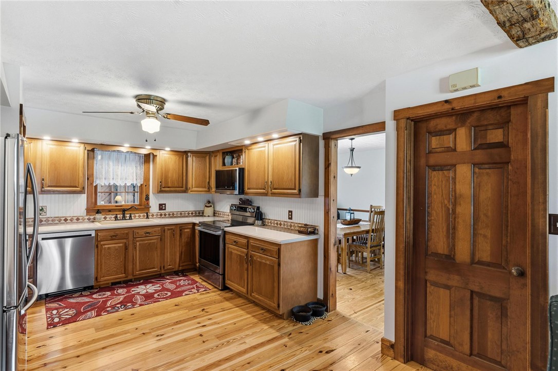 4971 Lackey Road Cedarville, OH 45314 - Photo 24 of 79 This warm and inviting kitchen showcases rich wood cabinetry and gleaming hardwood flooring.