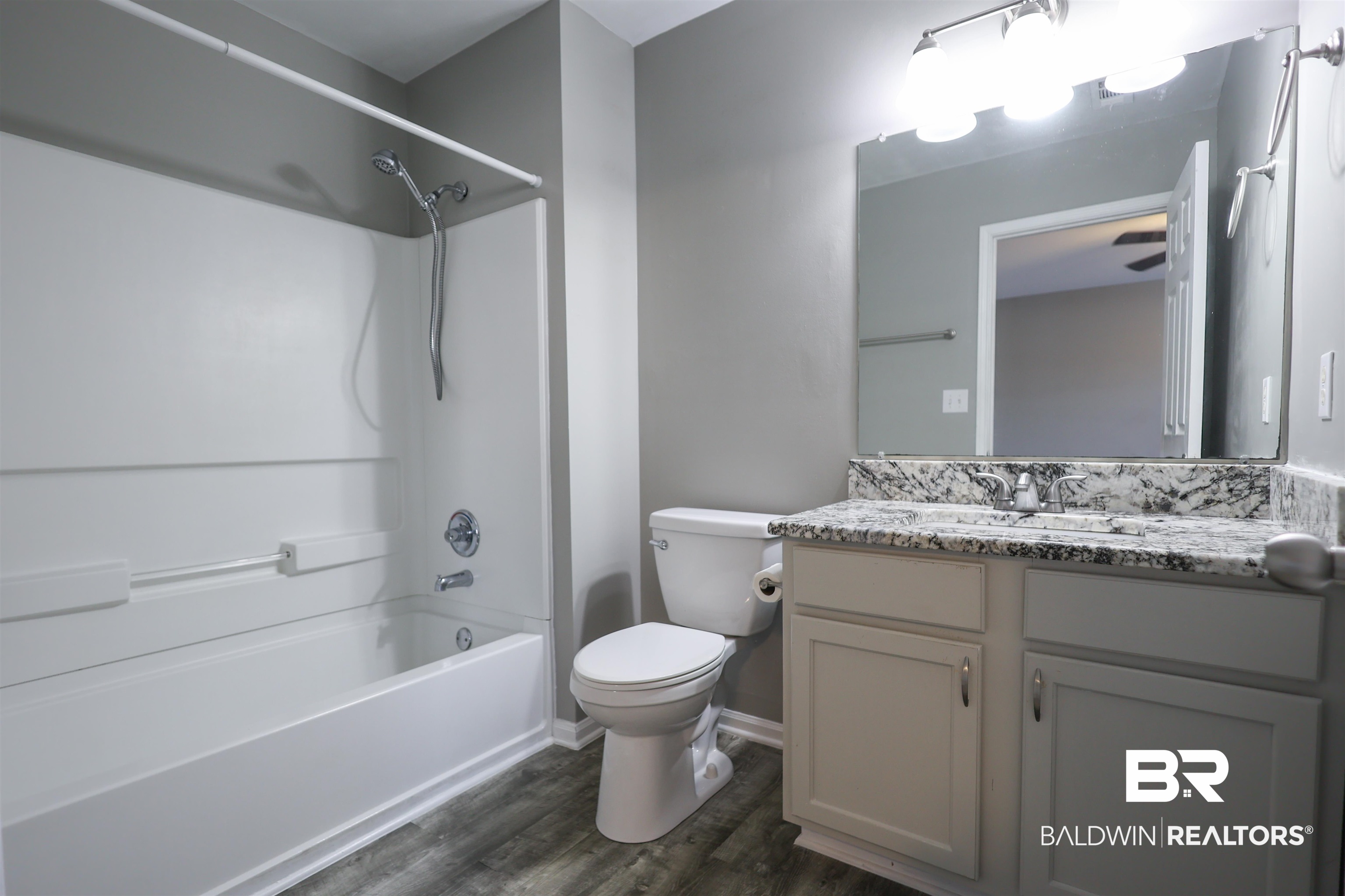 1517 Regency Road, Unit 125 Gulf Shores, AL 36542 - Photo 19 of 26 Full bathroom featuring tub / shower combination, vanity, and dark wood finished floors