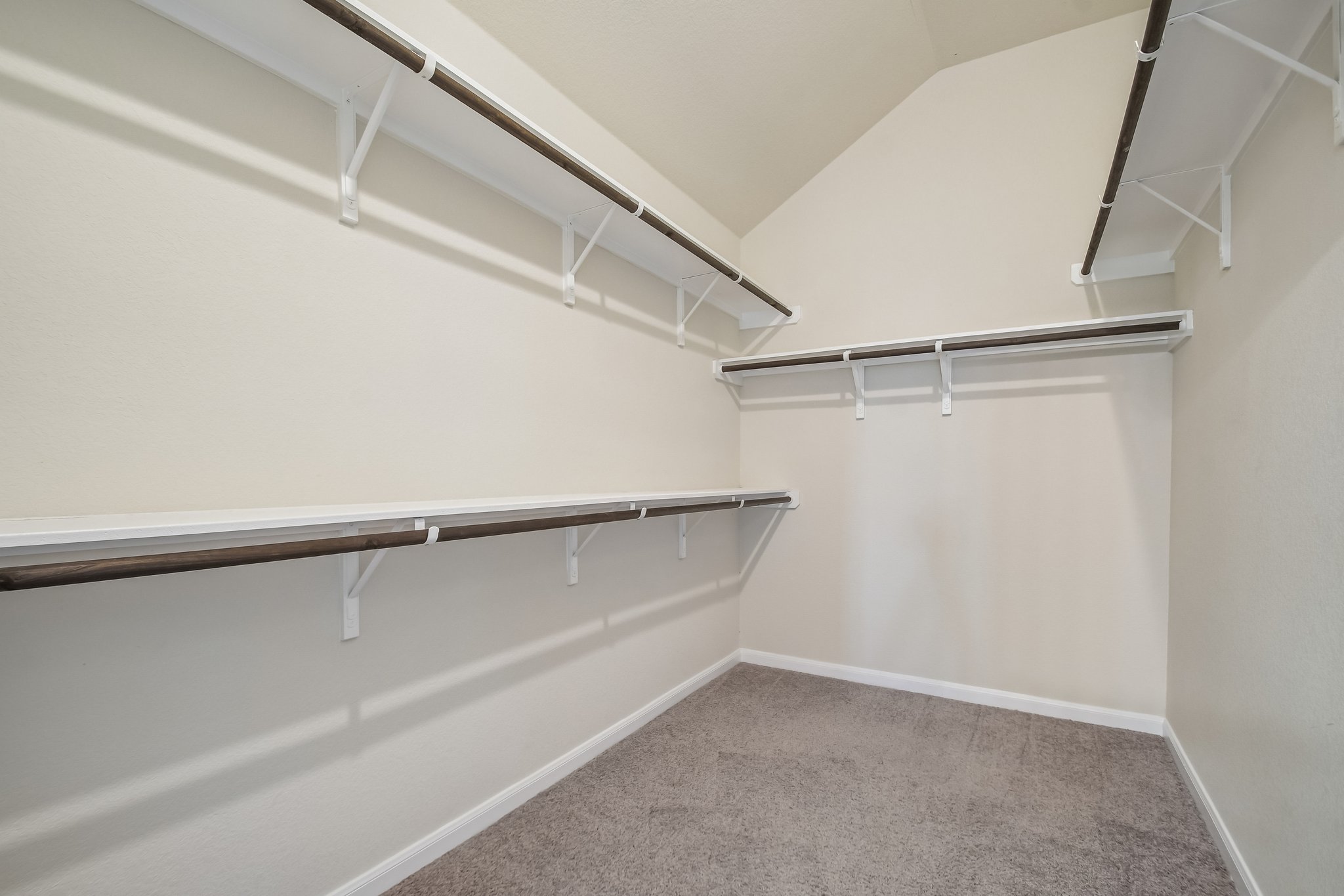 280 Rimrock Court Bastrop, TX 78602 - Photo 16 of 34 Ample built-in shelving and hanging rods maximize storage under vaulted ceilings.