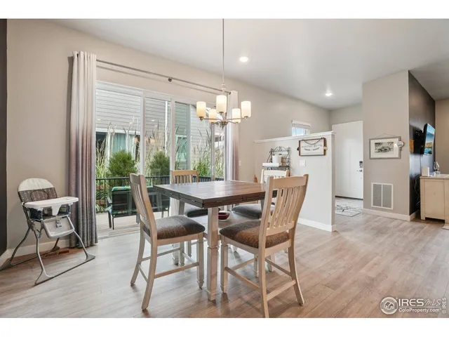a dining room with furniture and wooden floor