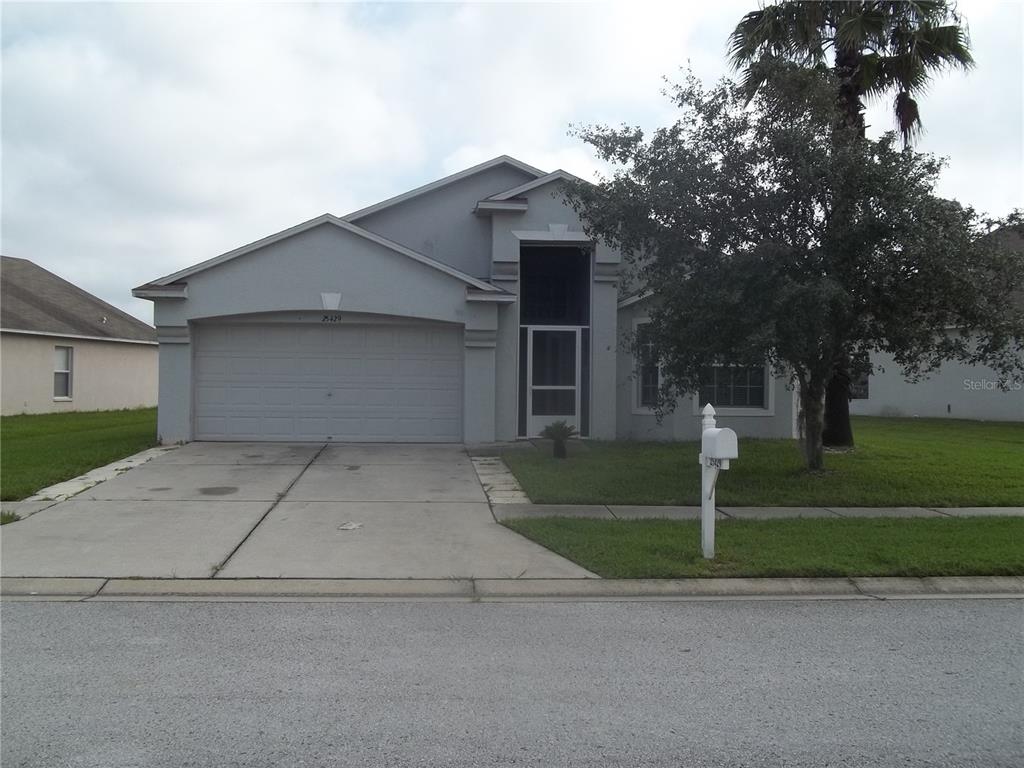 25429 Geddy Drive Land O Lakes, FL 34639 - Photo 1 of 1 front view of house with a yard and trees