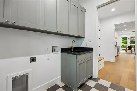 a kitchen with stainless steel appliances granite countertop a refrigerator sink and white cabinets