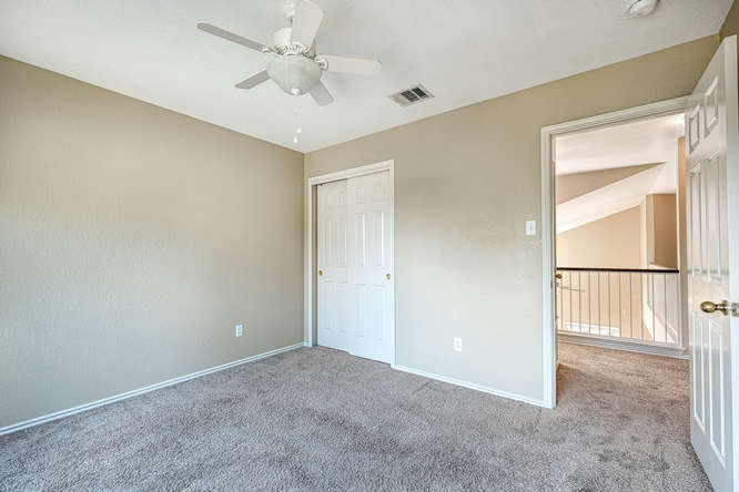 205 Polk Kyle, TX 78640 - Photo 14 of 22 Carpeted room with neutral wall tones and a ceiling fan
