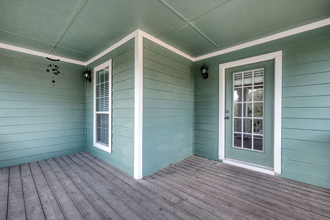 205 Polk Kyle, TX 78640 - Photo 17 of 22 Covered wood deck featuring siding exterior and white trim