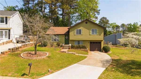 a view of house with swimming pool outdoor seating and house in the background