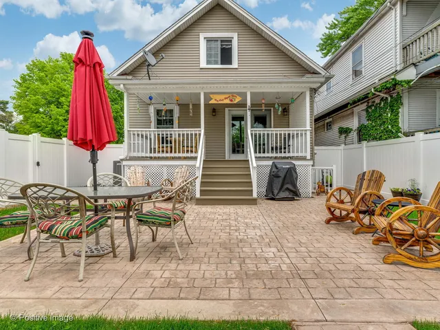 a view of a house with backyard sitting area and garden