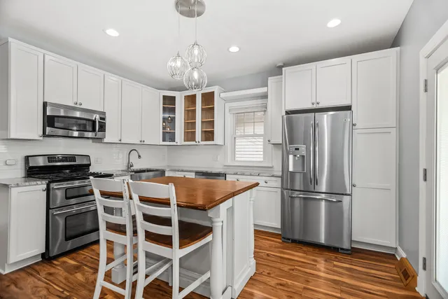 a kitchen with cabinets and stainless steel appliances