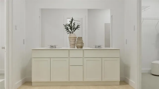 a white toilet sitting next to a bathroom sink