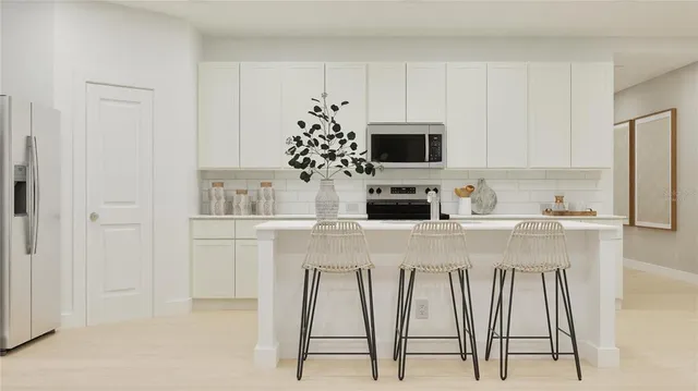 a kitchen with appliances a sink and cabinets