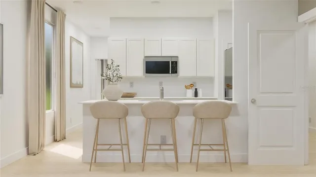 a utility room with cabinets washer and dryer
