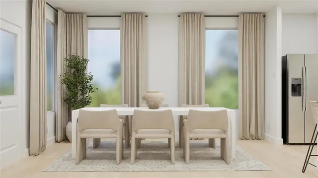 a view of a dining room with furniture and a potted plant