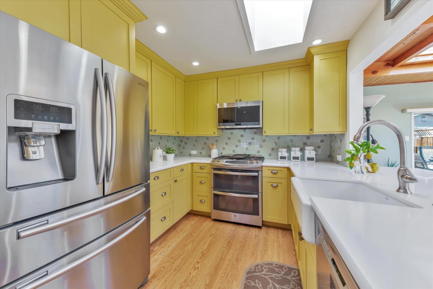 316 Greenway Drive Pacifica, CA 94044 - Photo 13 of 43 a kitchen with stainless steel appliances a sink cabinets and a counter top space