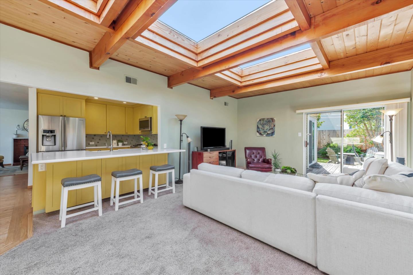 316 Greenway Drive Pacifica, CA 94044 - Photo 17 of 43 a living room with furniture a flat screen tv and a kitchen